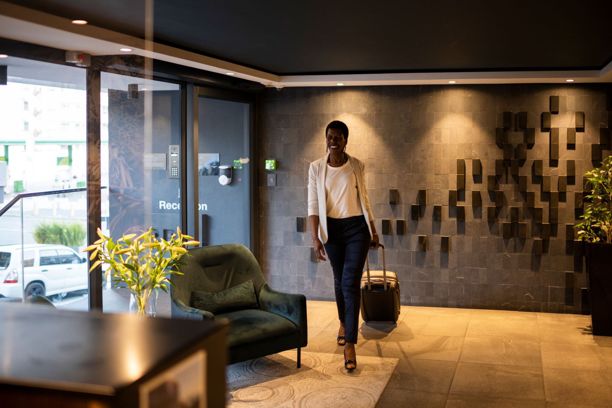 Wide-shot-businesswoman-enters-luxury-hotel-lobby-1401750460_resized
